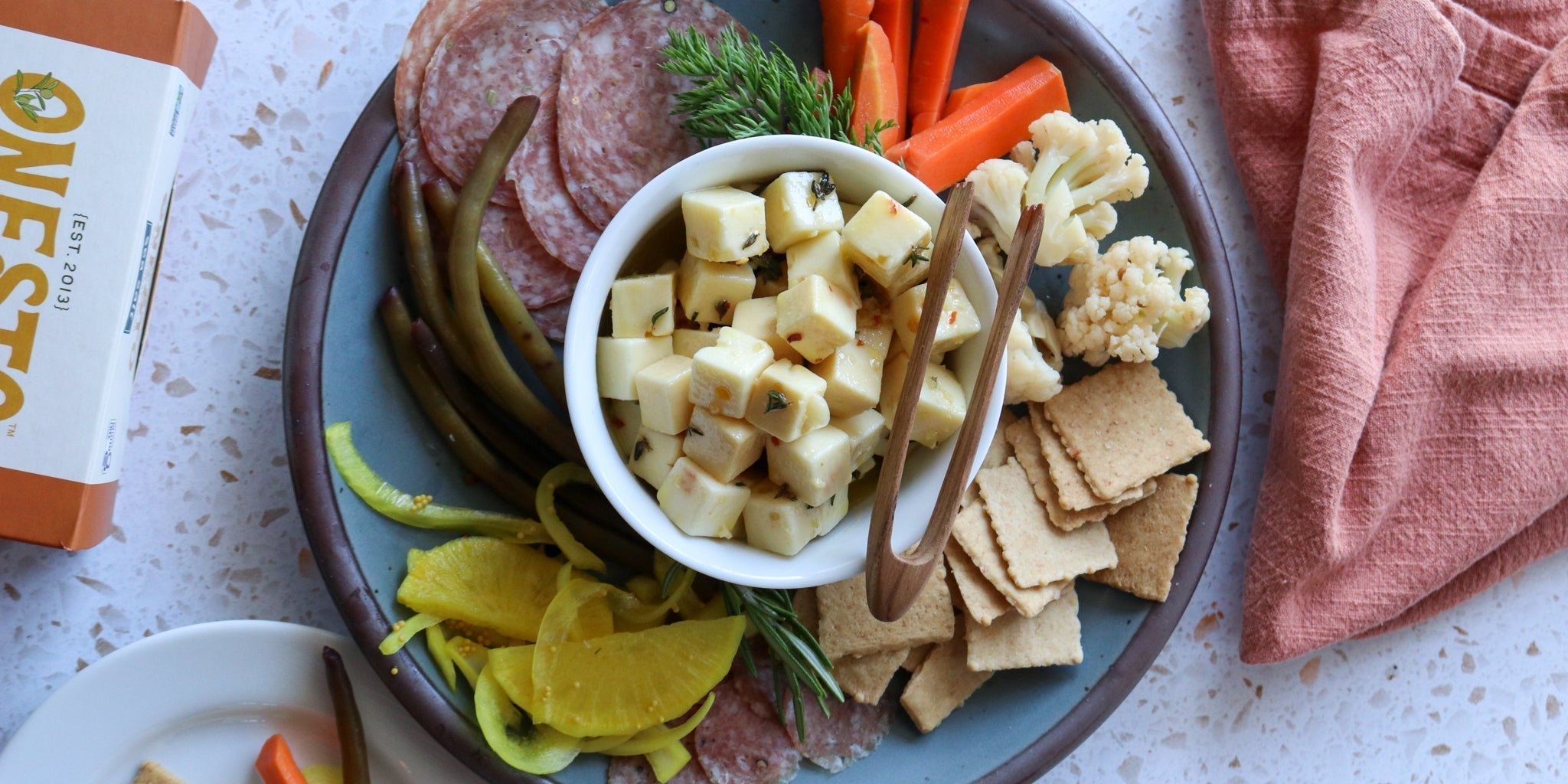 marinated toma cubes on a plate with pickles