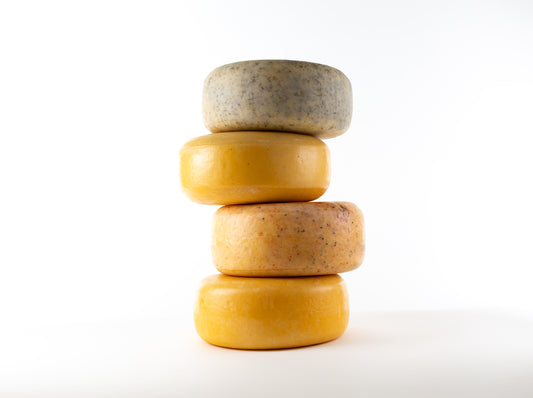 stacked wheels of toma cheese