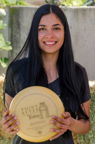 Employee holding cheese 6