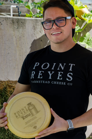 Employee holding cheese 5