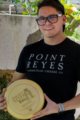 Employee holding cheese 5