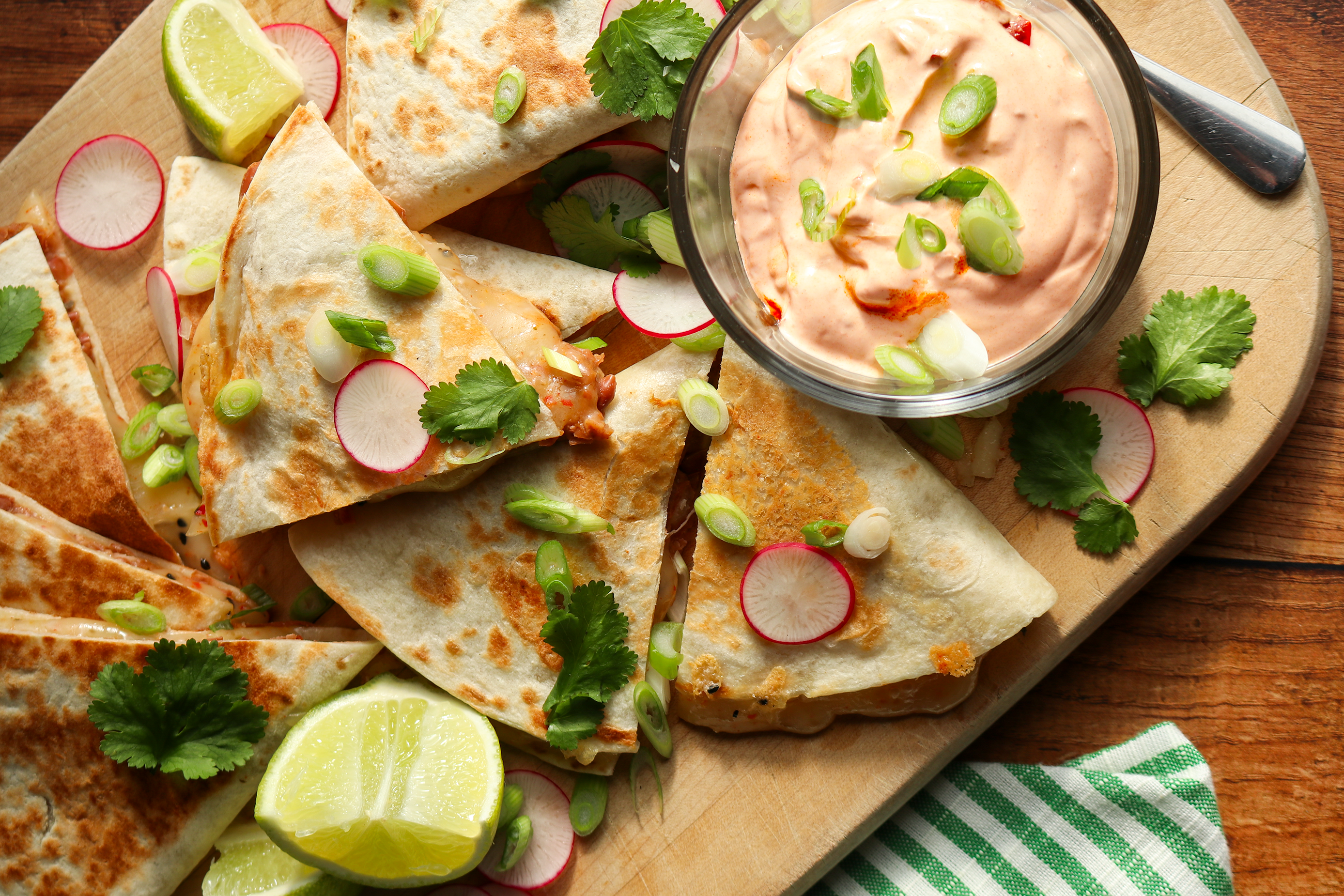 Bean and cheese quesadillas in triangles on boardd
