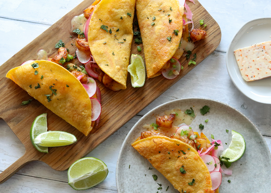 Cheesy Shrimp Tacos on a wooden board