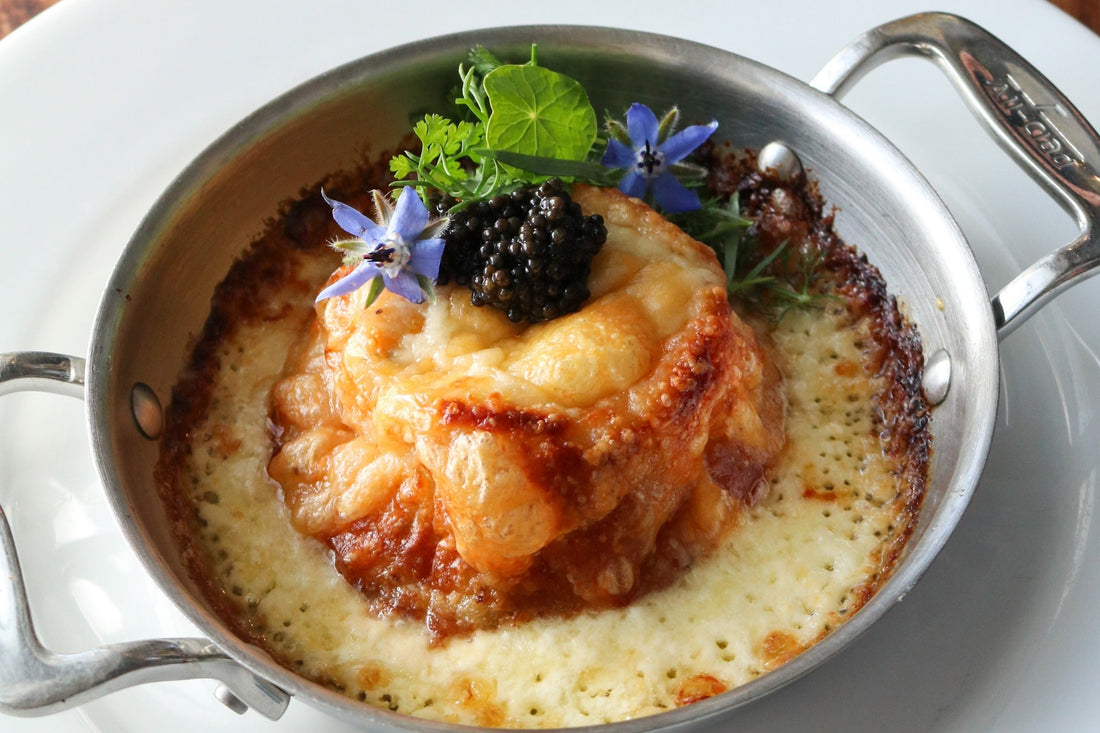 TomaTruffle and crab souffle topped with caviar in metal dish