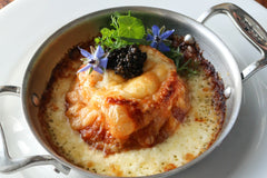 TomaTruffle and crab souffle topped with caviar in metal dish