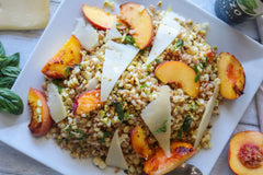 Grilled peach and corn salad with Toma on a plate