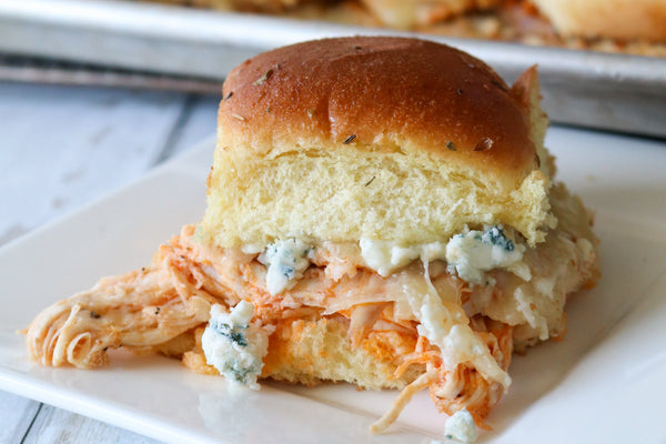 buffalo chicken slider on a roll with original blue crumbles on a plate