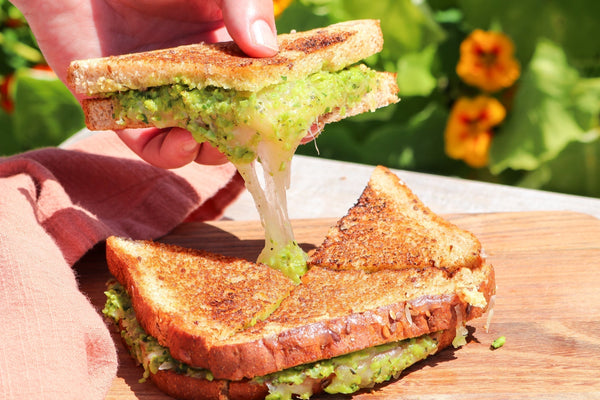 grilled cheese with spring pea puree on a board