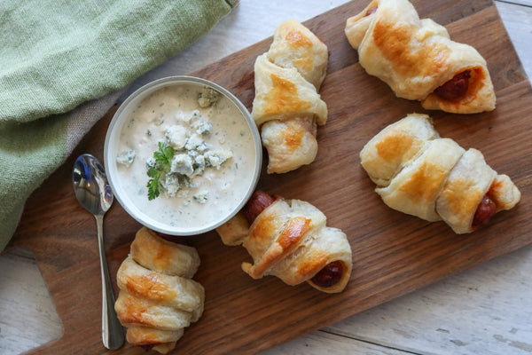 pigs in blankets with bay Blue dip on a board 