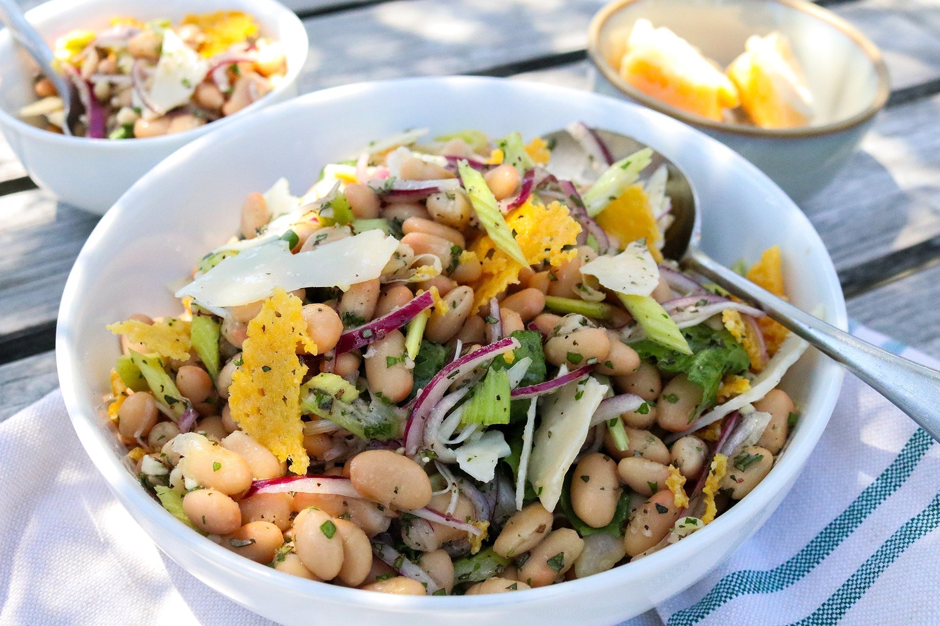 white bean salad with gouda frico in bowl