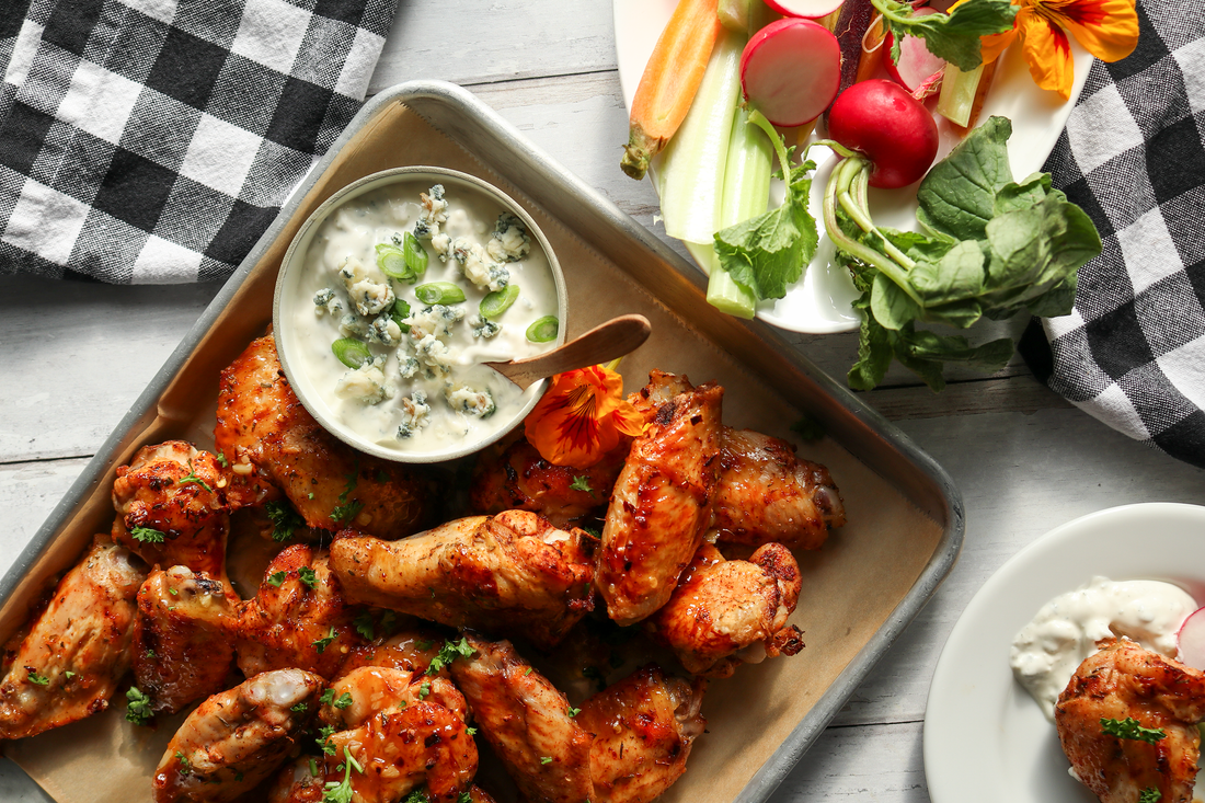 chicken wings on a platter with blue cheese dip