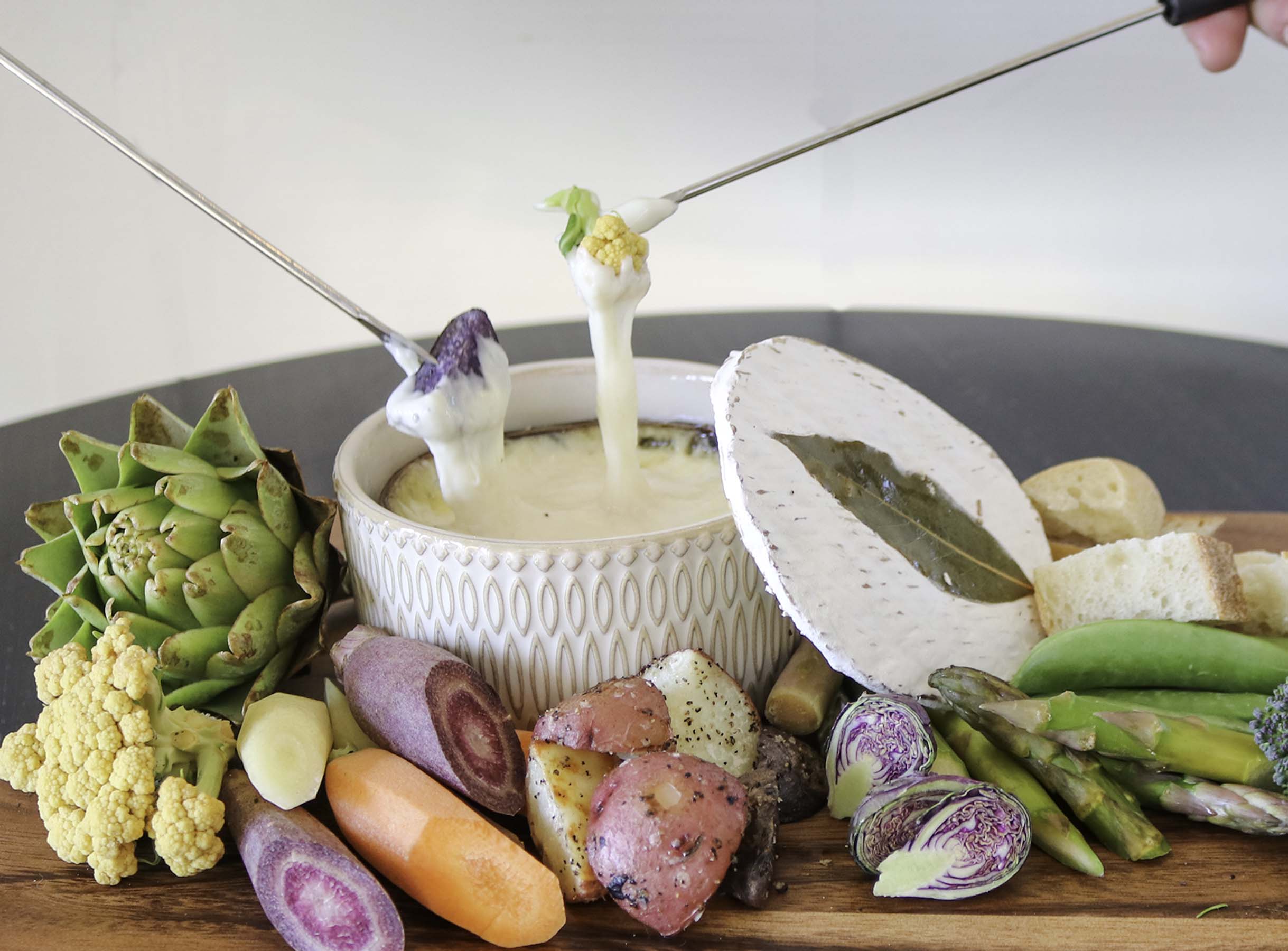 Quinta fondue surrounded by spring vegetables
