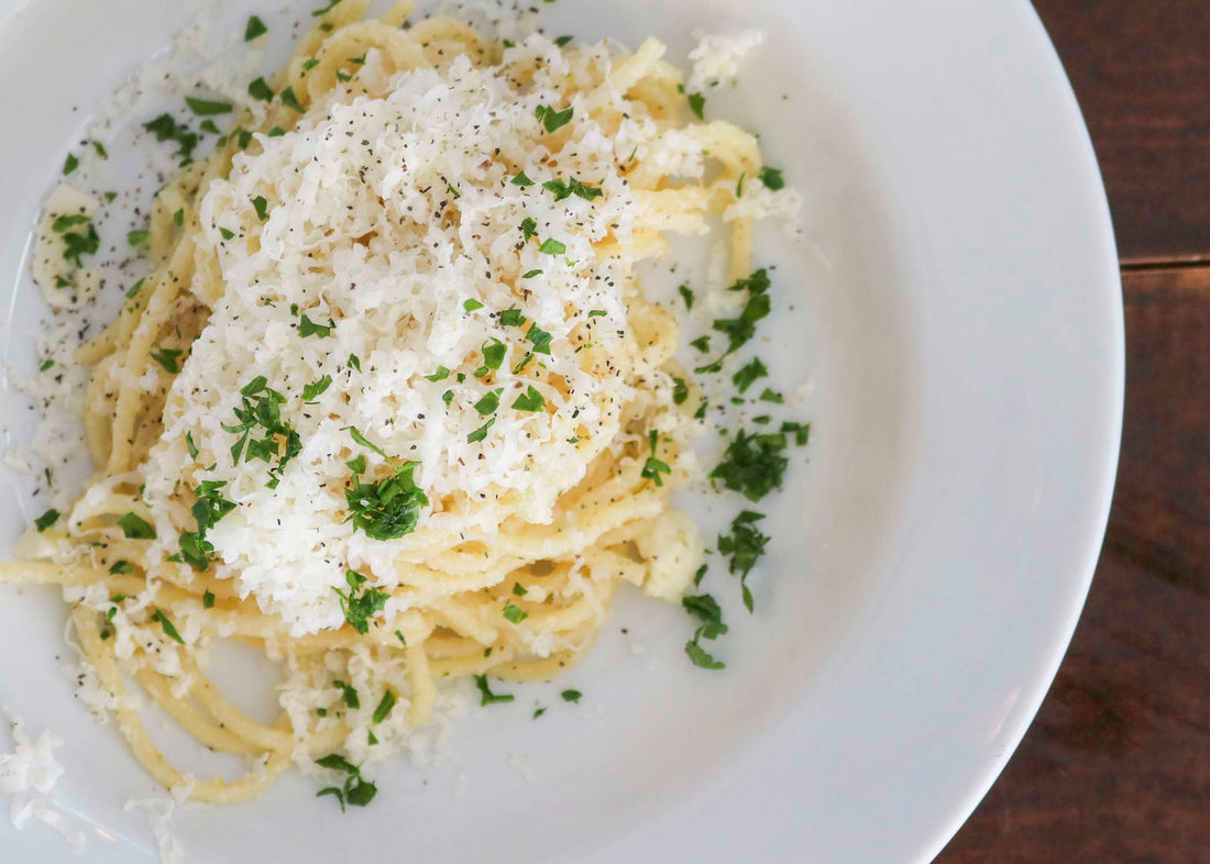 Cheesy TomaTruffle pasta with shredded cheese and parsley on top
