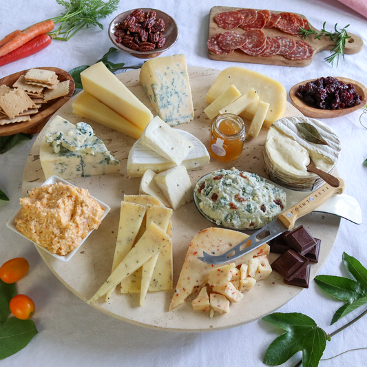 Celebration collectio0j cheese gift pack prepared on a round board