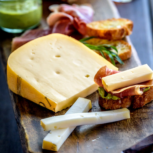 Toma with crostini on a board