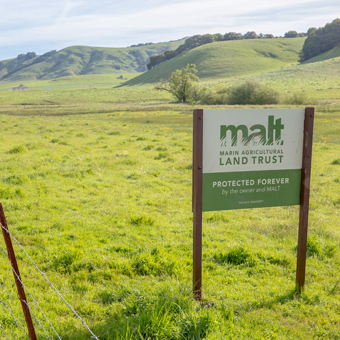 a green pasture with a sign for MALT