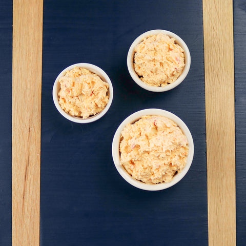 Product: Pimento cheese spread in three bowls on a blue board