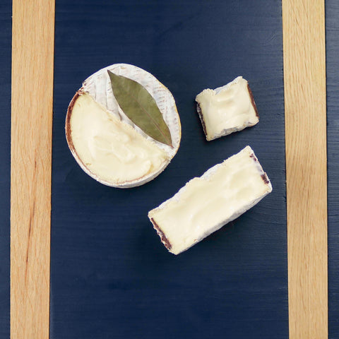 Product: Cut wheels of Quinta cheese on a blue cheeseboard
