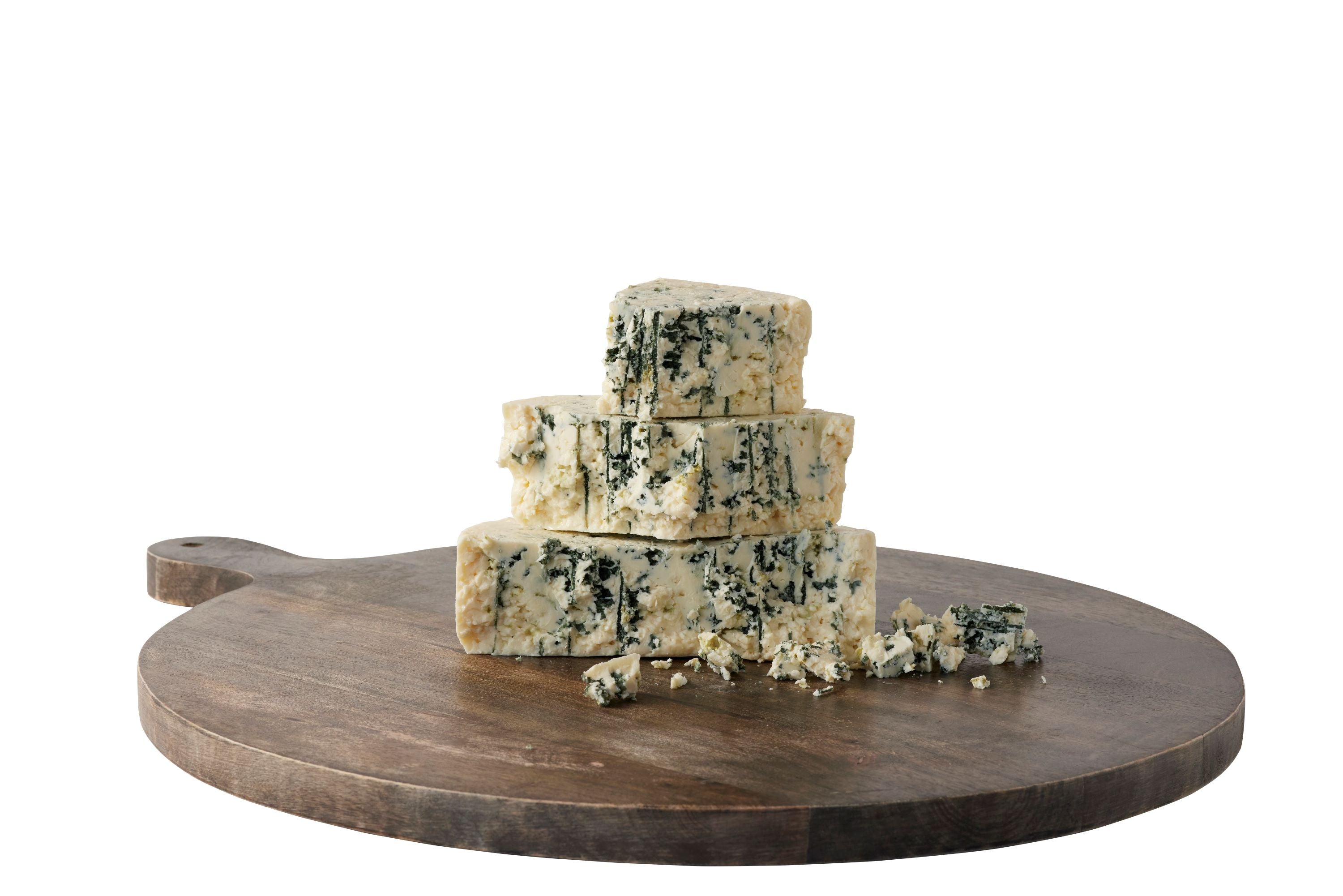 Original Blue cheese cut into pieces stacked on a brown cheeseboard 