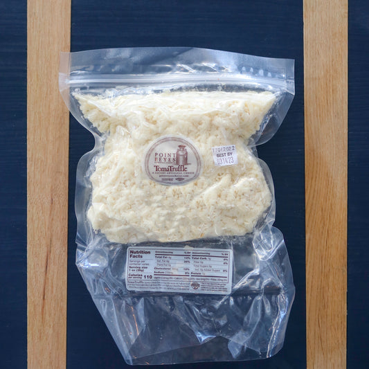 A plastic bag containing shredded TomaTruffle cheese